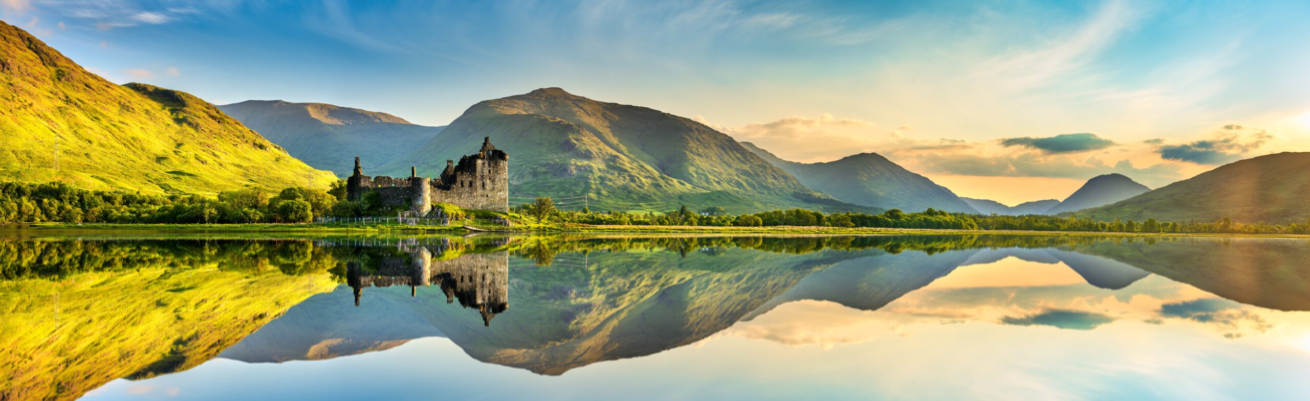 Misty loch and green hills in the Scottish Highlands